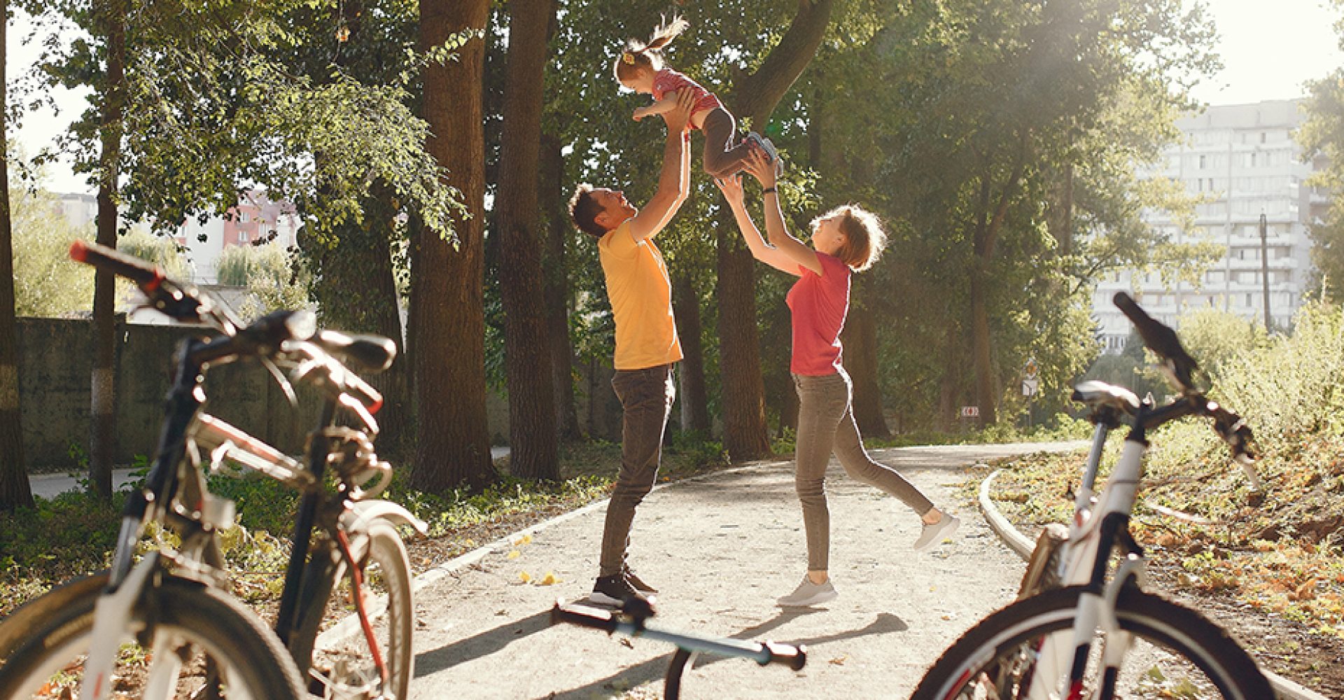 Family with a bicycle in a summer park