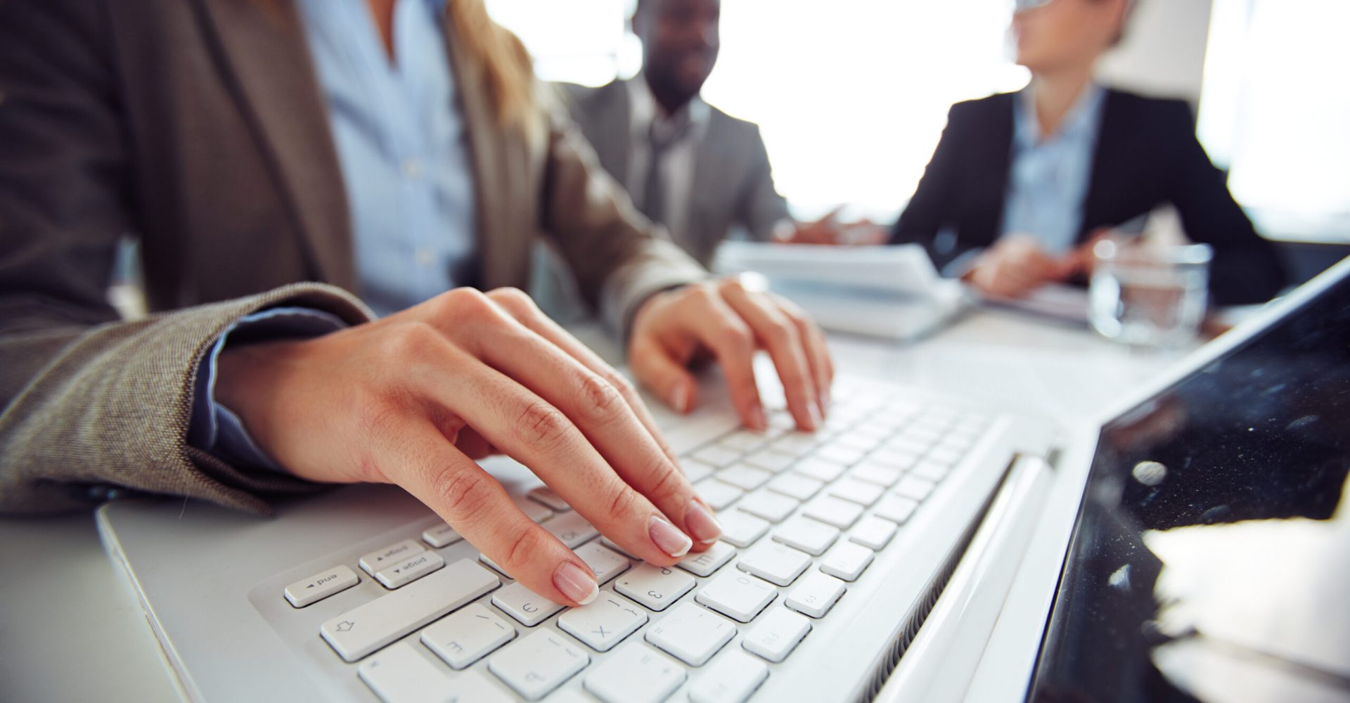 Hands of female employee typing