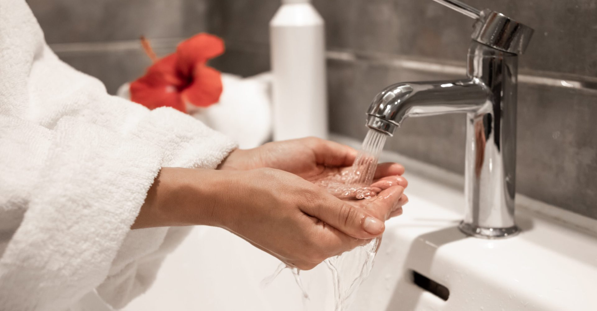 Close up of a girl washes her hands in the bathroom.