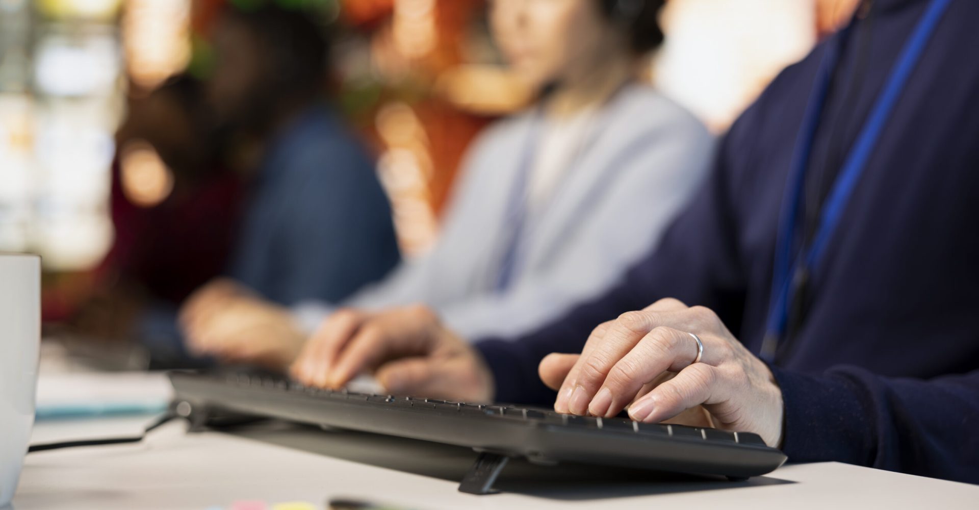Call center agent typing on PC keyboard, assisting customers through digital communication channels. Customer support employee using computer to have conversation with client in live chat, close up