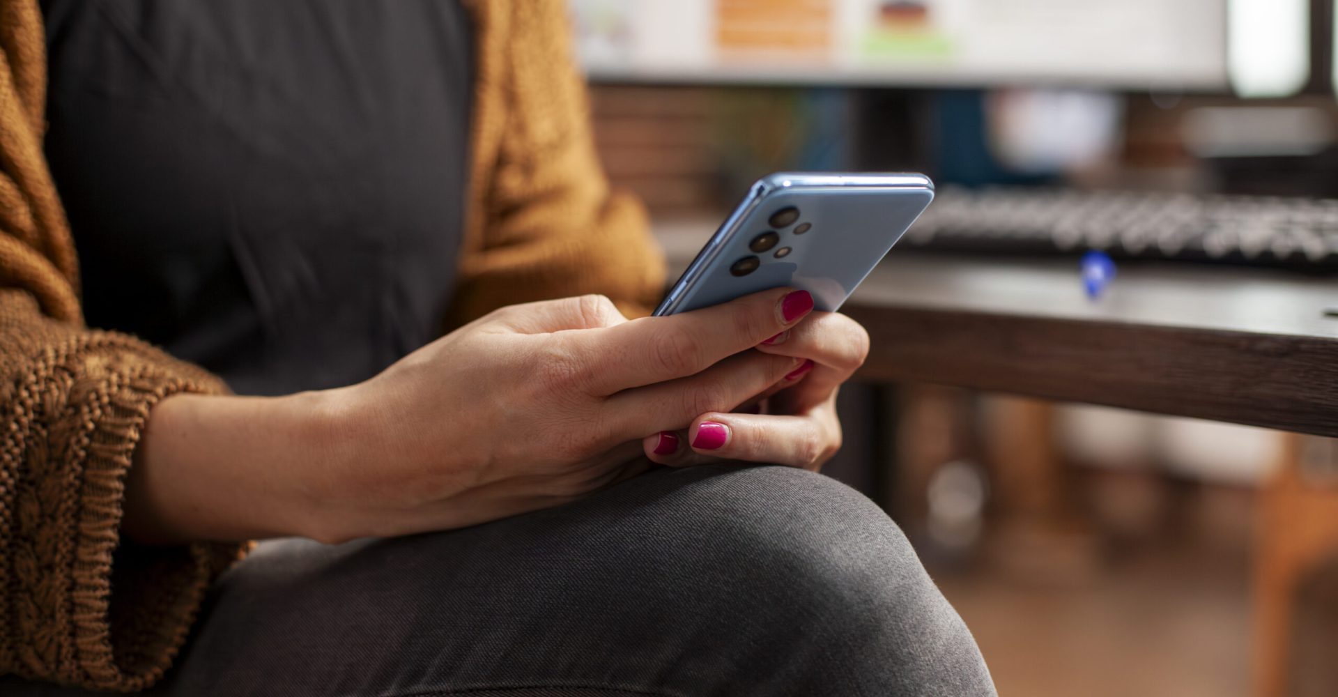 Female employee holding mobile device