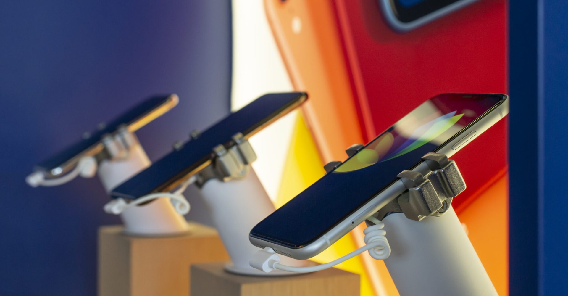 Cell Phones on shelf in telecommunication shop. Lights over GSM