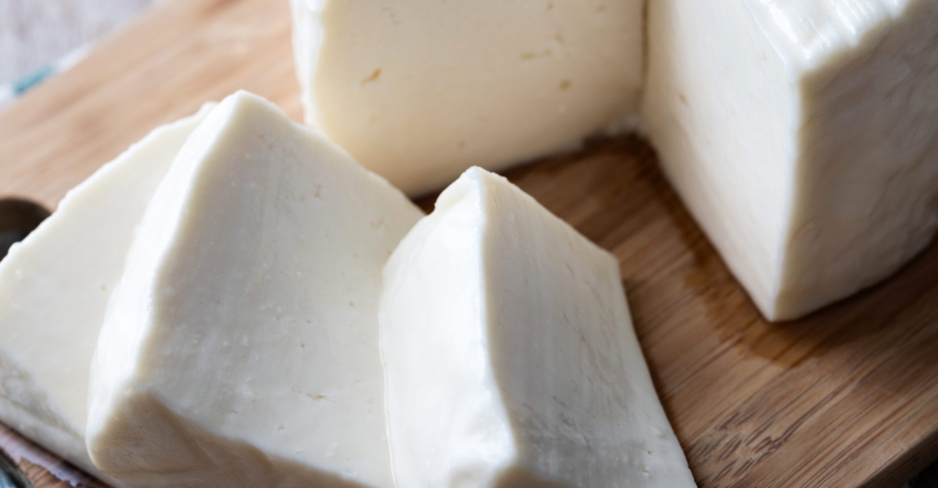 Sliced fresh white cheese from cow's milk on white background