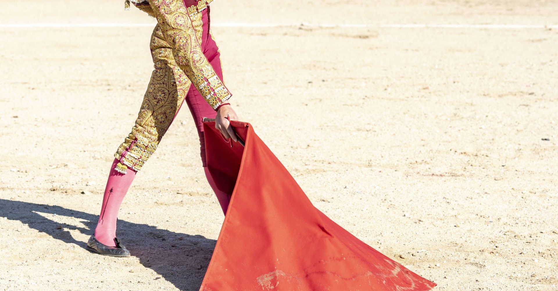 Picture of a bullfighter or matador in traditional clothes and red fabric