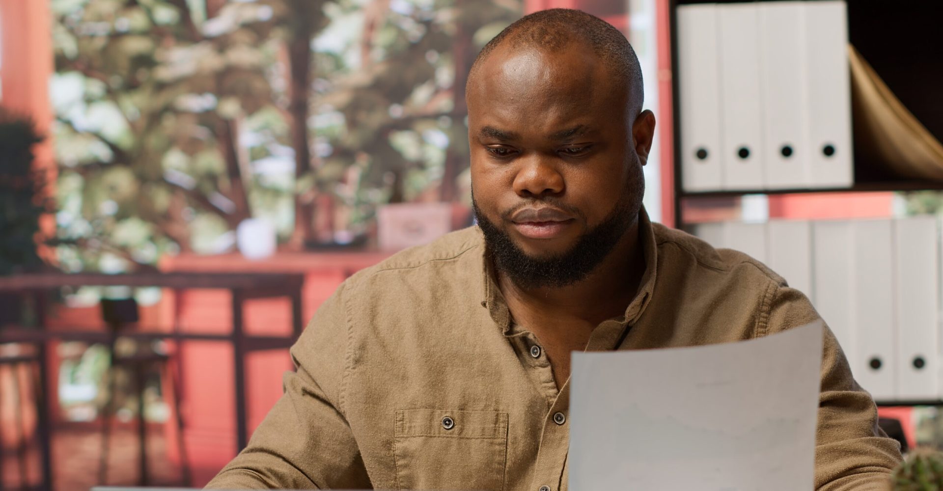 Entrepreneur taking notes and managing business analytics at his home office