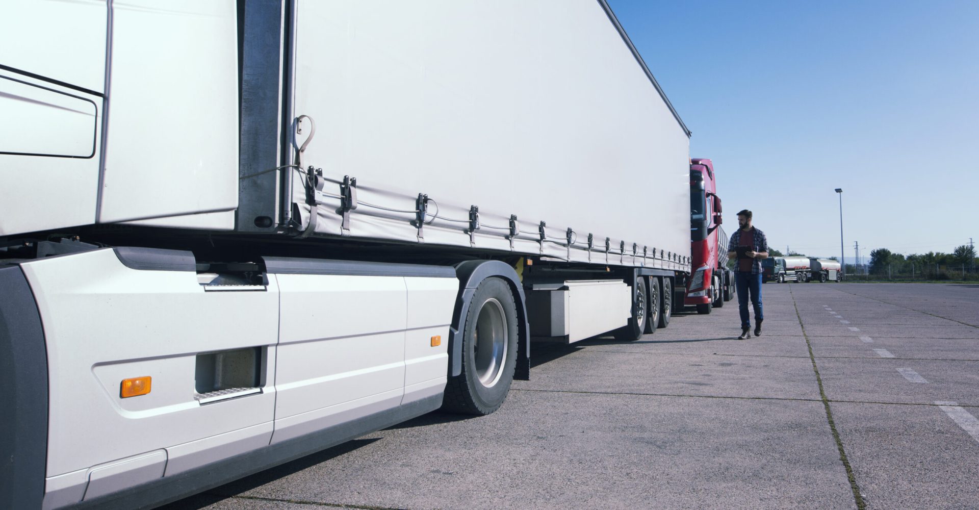 Truck driver inspecting truck long vehicle before driving.