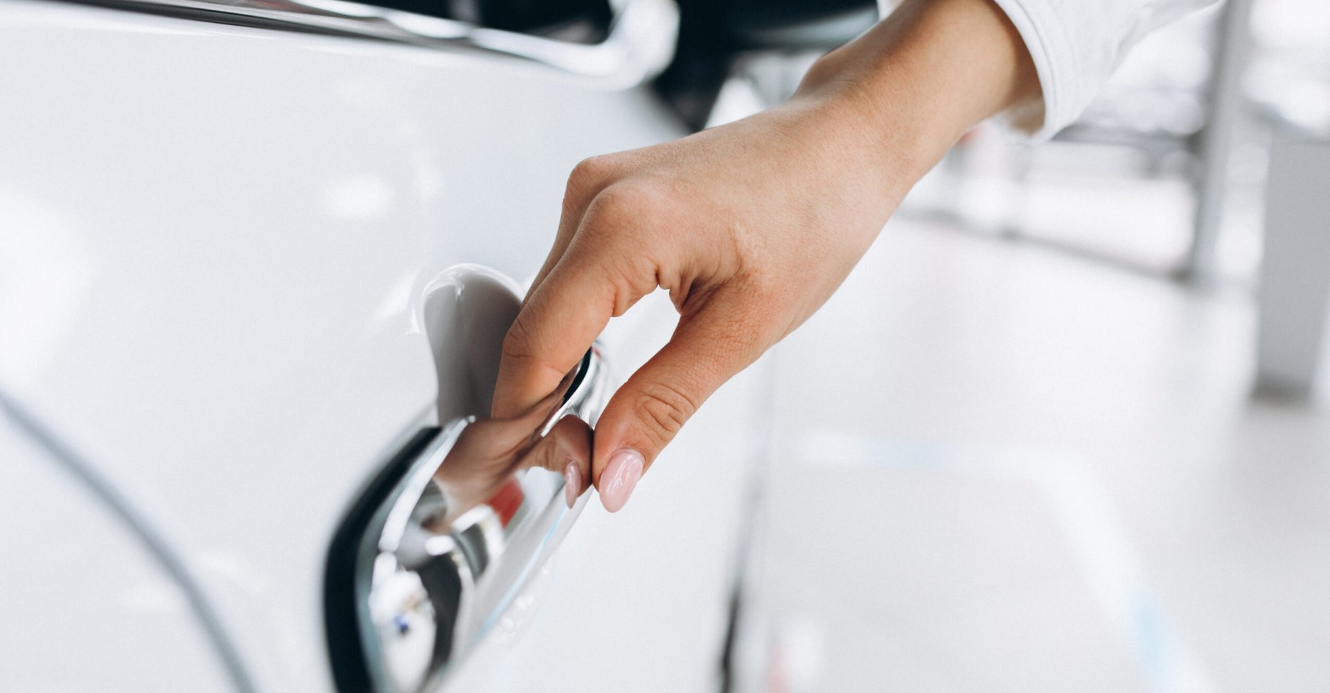 Female hand opening car close up
