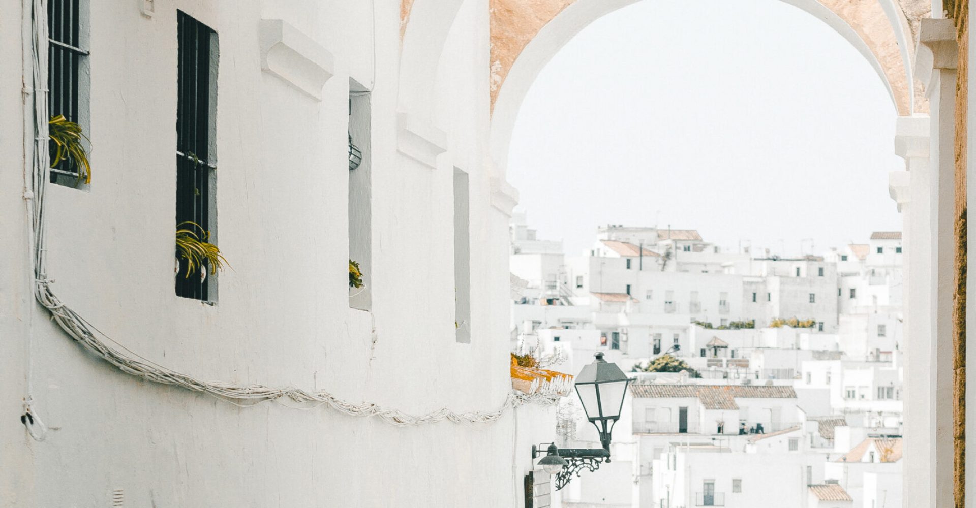 Vertical shot of a female walking in the narrow streets of Cadiz
